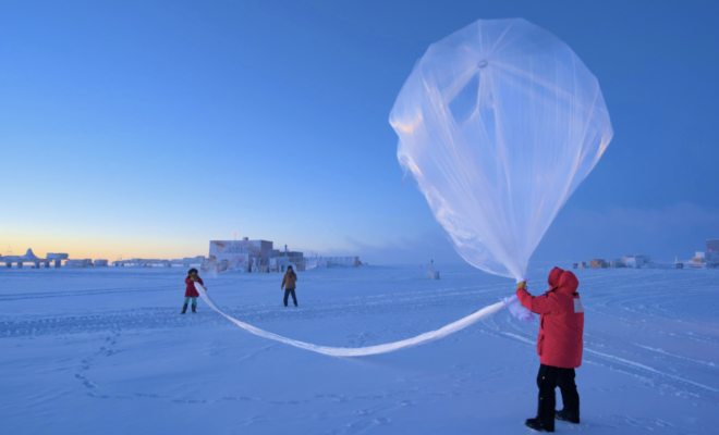 NOAA scientists launch a weather balloon carrying an ozonesonde at the South Pole on October 1, 2023. (Image credit: Marc Jaquart/IceCube)